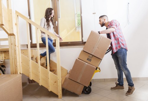 Removal team navigating stairs in a Nunhead flat move