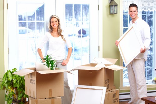 Moving team unloading boxes and furniture near Nunhead homes